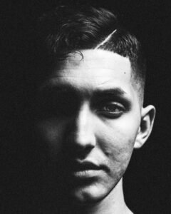 A Rembrandt black and white portrait of a handsome young man