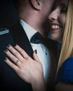 a professional portrait of a young couple showcasing their marriage ring